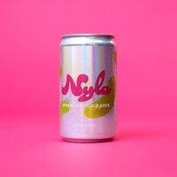A silver aluminum can of Nylah soda with pink and yellow graphics, standing upright on a solid pink background.